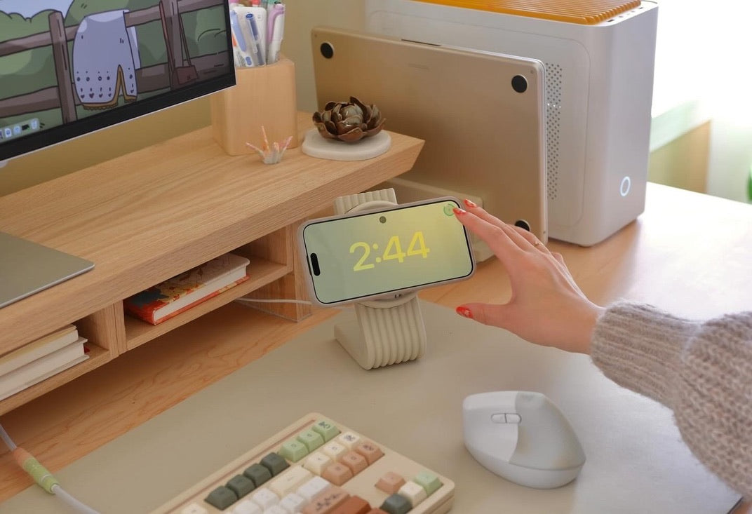 Phone turned sideways on the Zen MagSafe Charger Stand, showing a clock while it charges