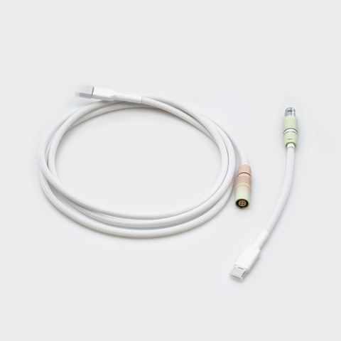 The Zen Cable, coiled, in white with pastel connectors