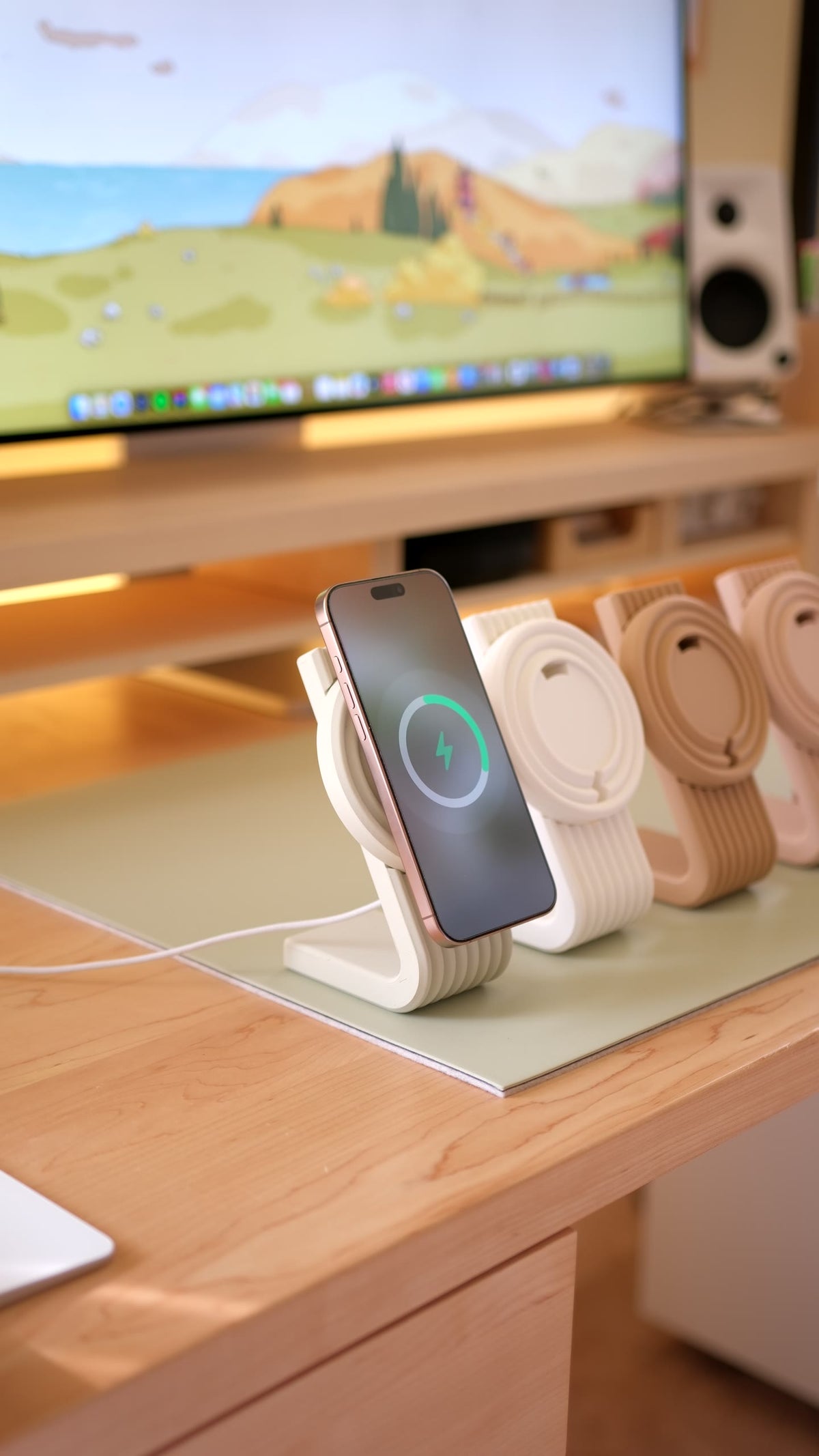 An iPhone charging on a cream Zen MagSafe Charger Stand