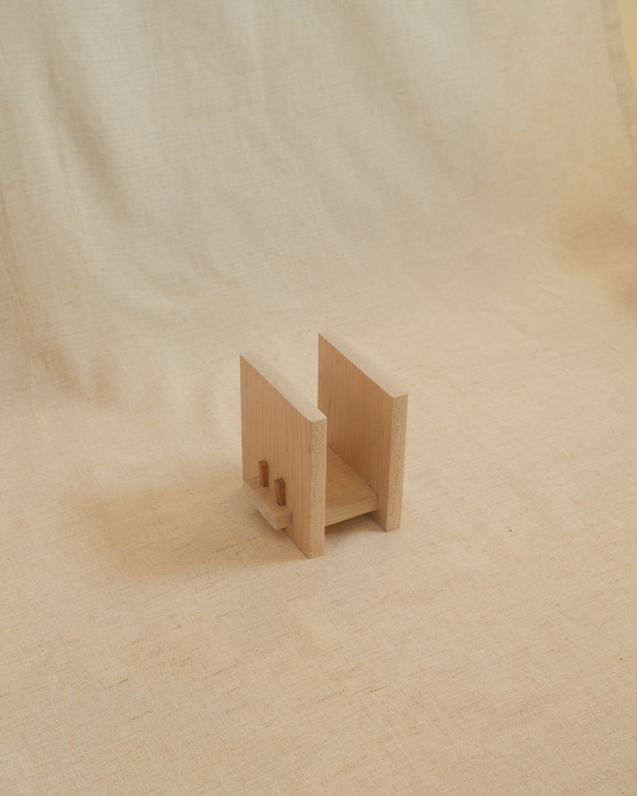Zen Book Stand in Maple, Small, on a linen backdrop