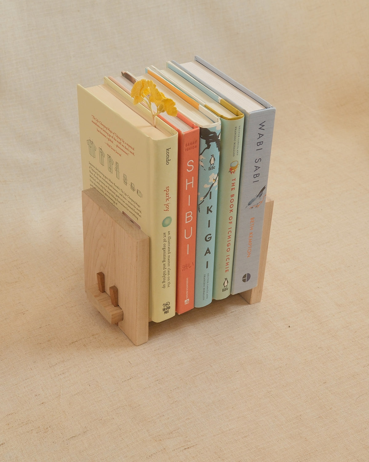A Zen Book Stand holding books on linen