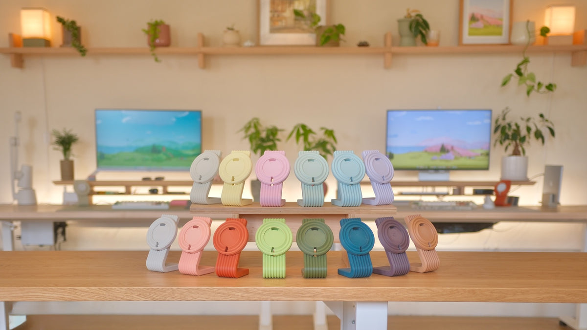 Zen MagSafe Charger Stands lined up in pastel colors on a desk