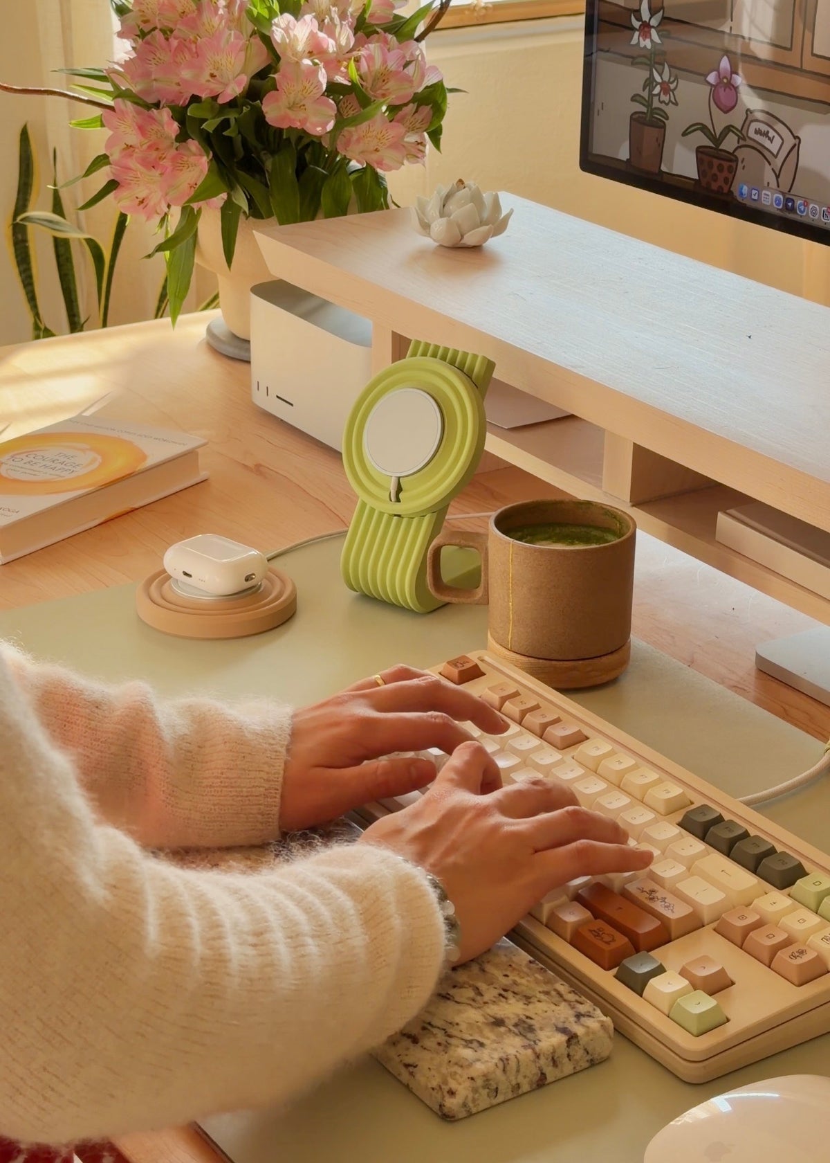 Zen MagSafe Charger Puck holding AirPods next to a matcha cup and keyboard on a green desk mat