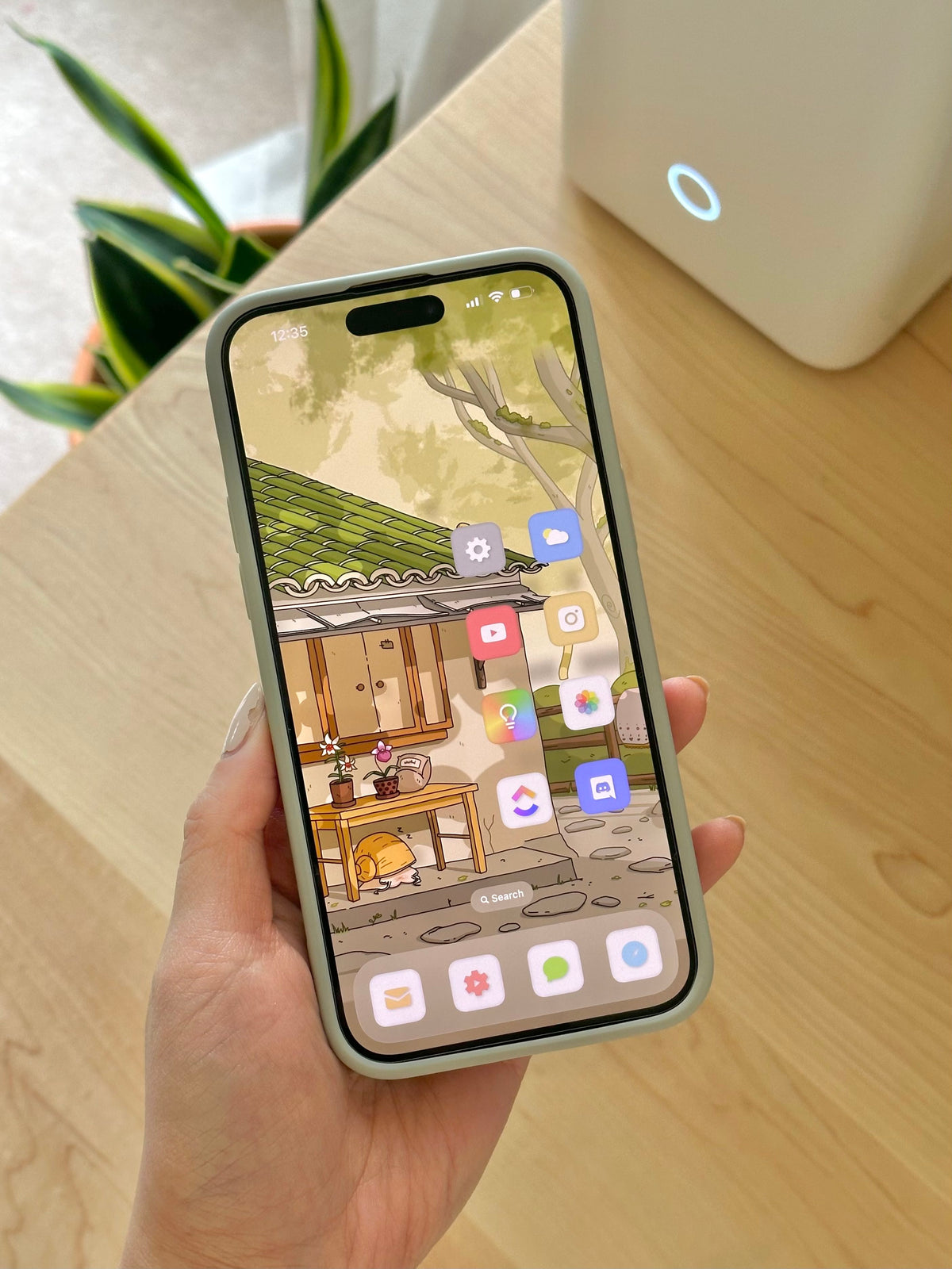 A phone home screen with Cozyleigh app icons and wallpaper