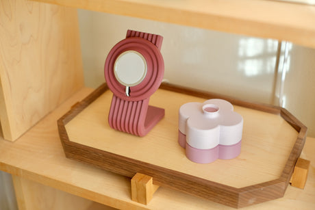 Coming this fall: the Zen MagSafe Charger Stand in Burgundy on a walnut Zen Tray beside a Lavender Fa Trinket Tray, on a bookshelf