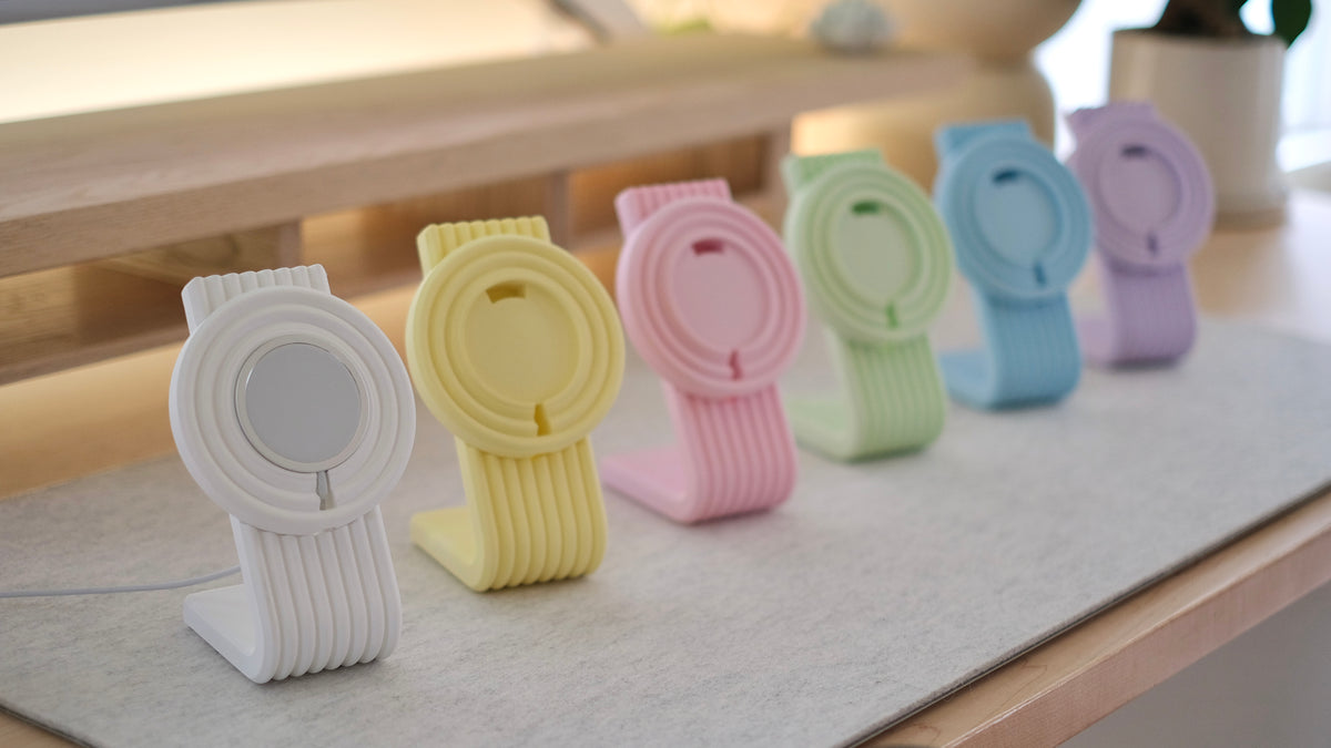 Zen MagSafe Charger Stands lined up in pastel colors on a desk