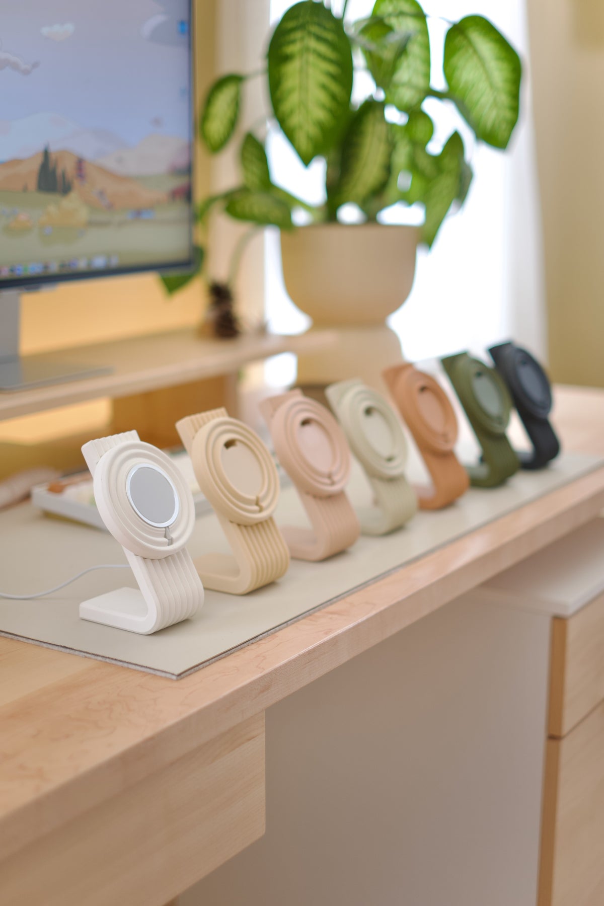 Zen MagSafe Charger Stands lined up in pastel colors on a desk