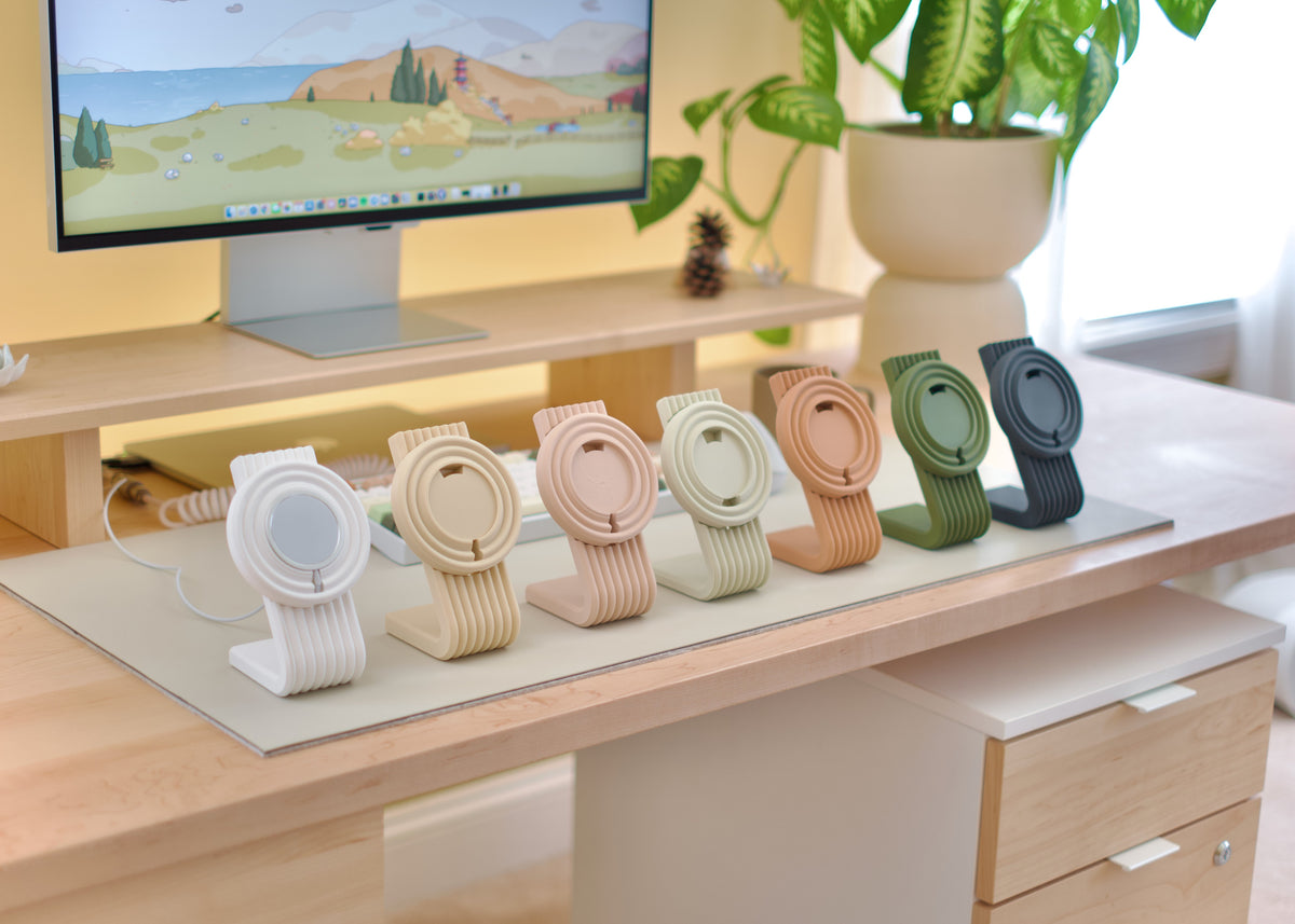 Zen MagSafe Charger Stands lined up in pastel colors on a desk
