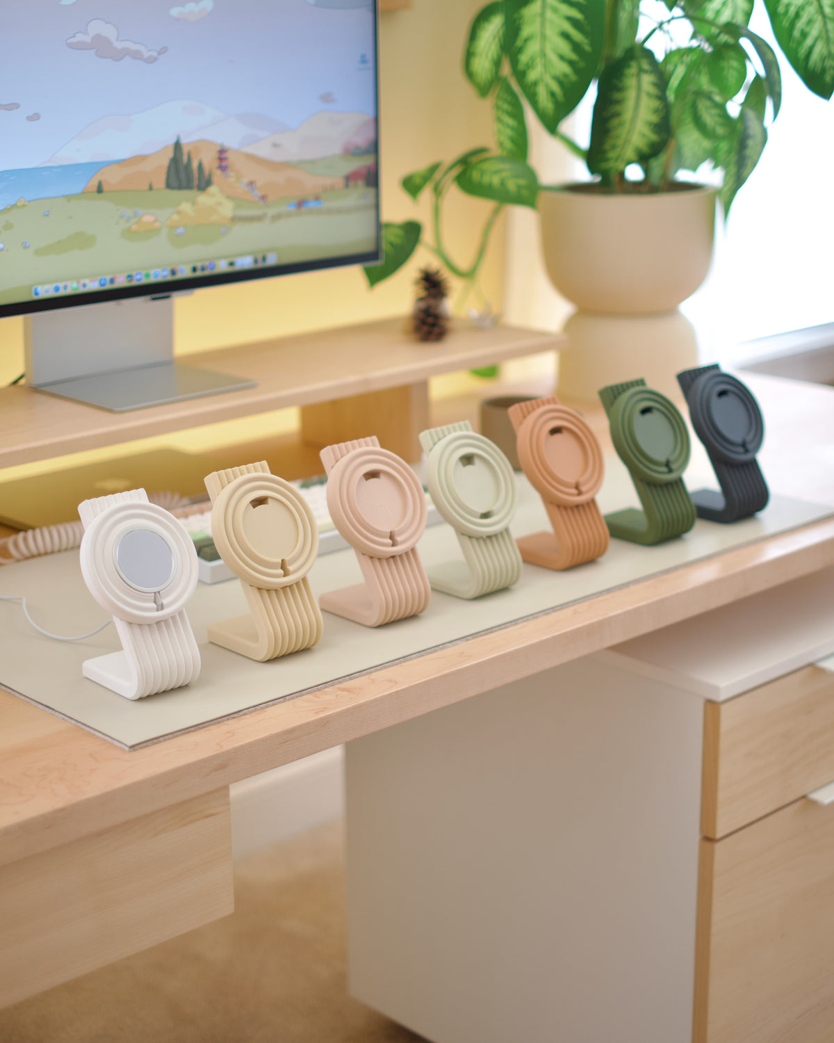 Zen MagSafe Charger Stands lined up in pastel colors on a desk