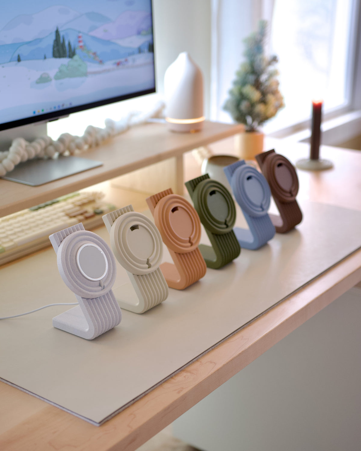 Zen MagSafe Charger Stands lined up in pastel colors on a desk