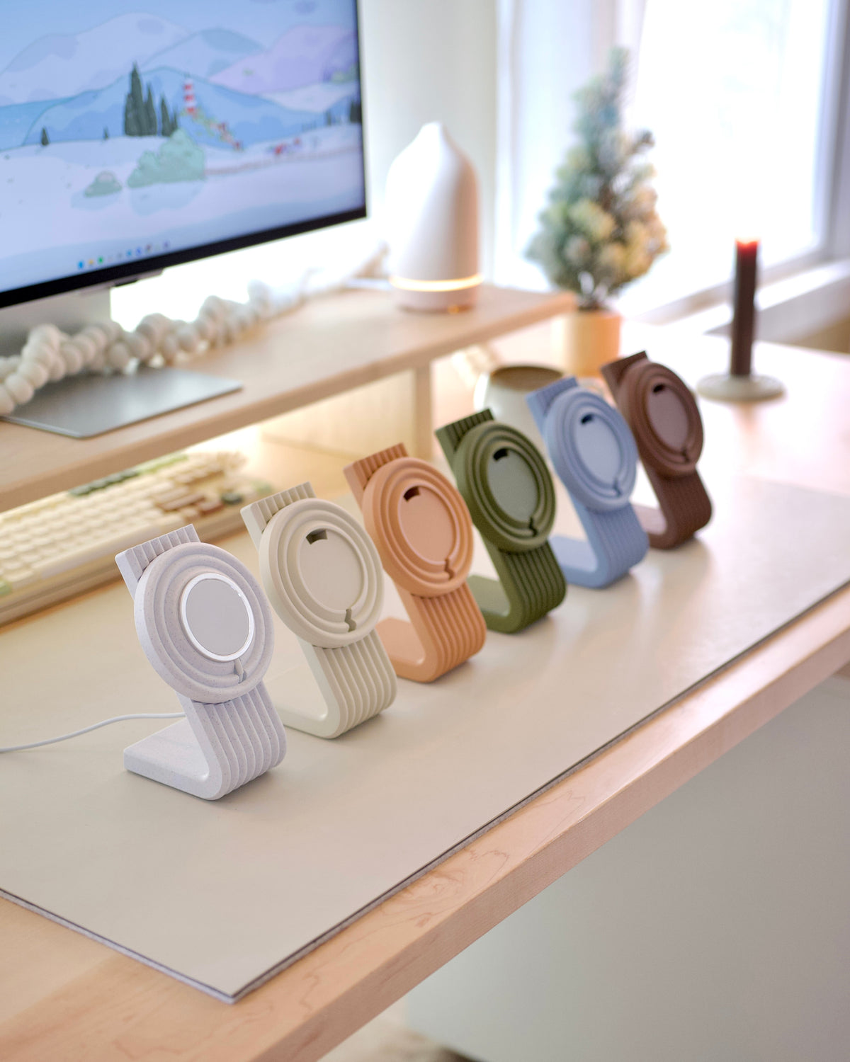 Zen MagSafe Charger Stands lined up in pastel colors on a desk