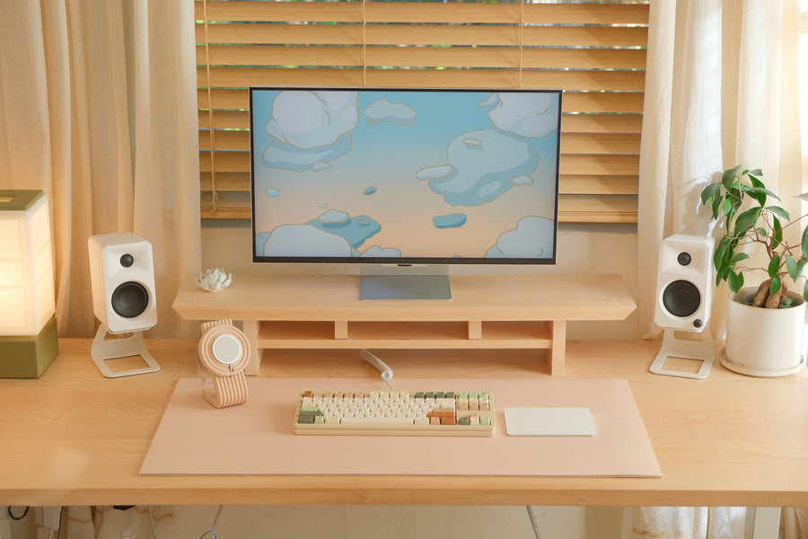 Cozyleigh Desk Mat, Large, in Blush on the studio desk with the Zen MagSafe Charger Stand