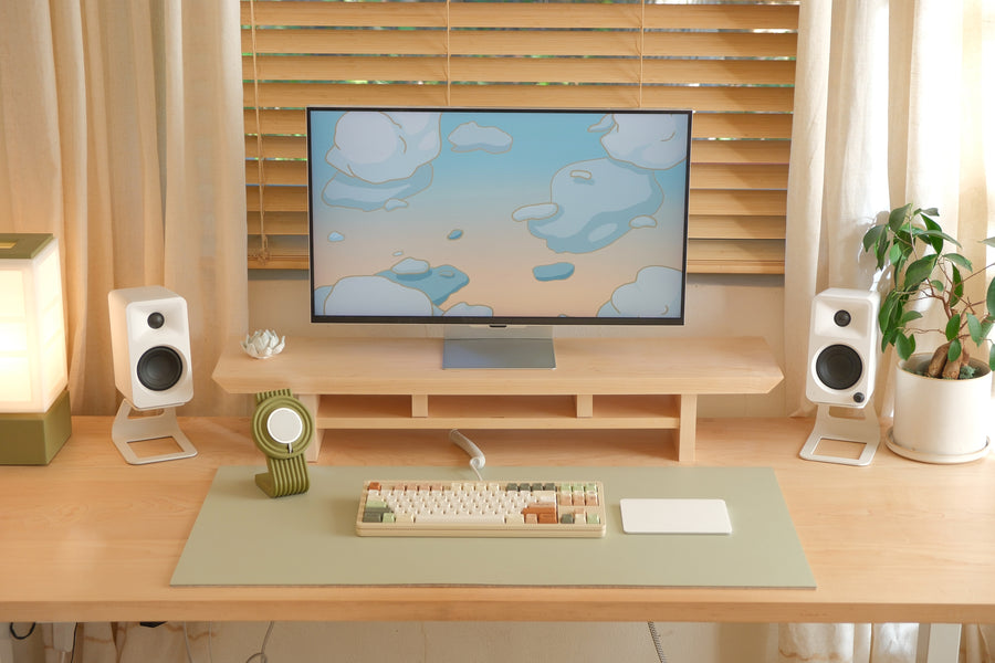 Cozyleigh Desk Mat, Large, in Matcha on the studio desk with the Zen MagSafe Charger Stand