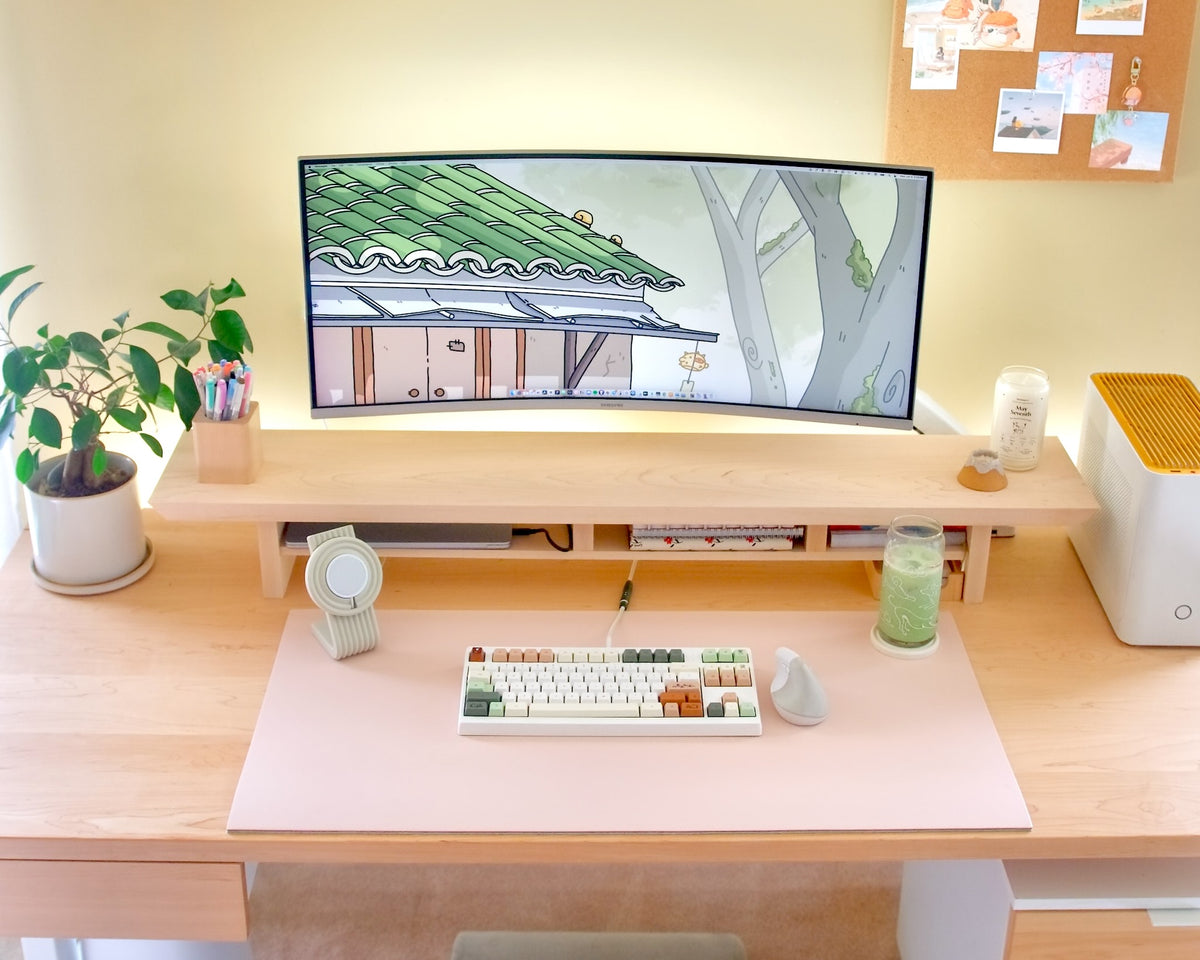 A desk setup on the blush desk mat, large size