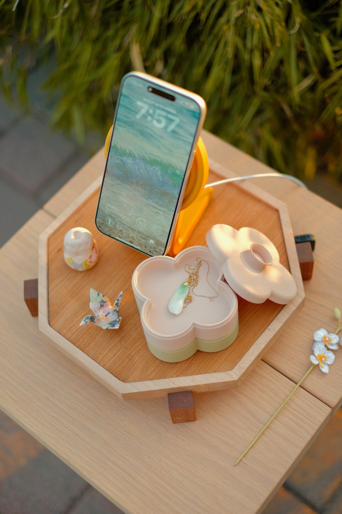 Fa Trinket Trays in Dusty Blush and Pistachio with a necklace, next to an iPhone on a Zen MagSafe Charger Stand