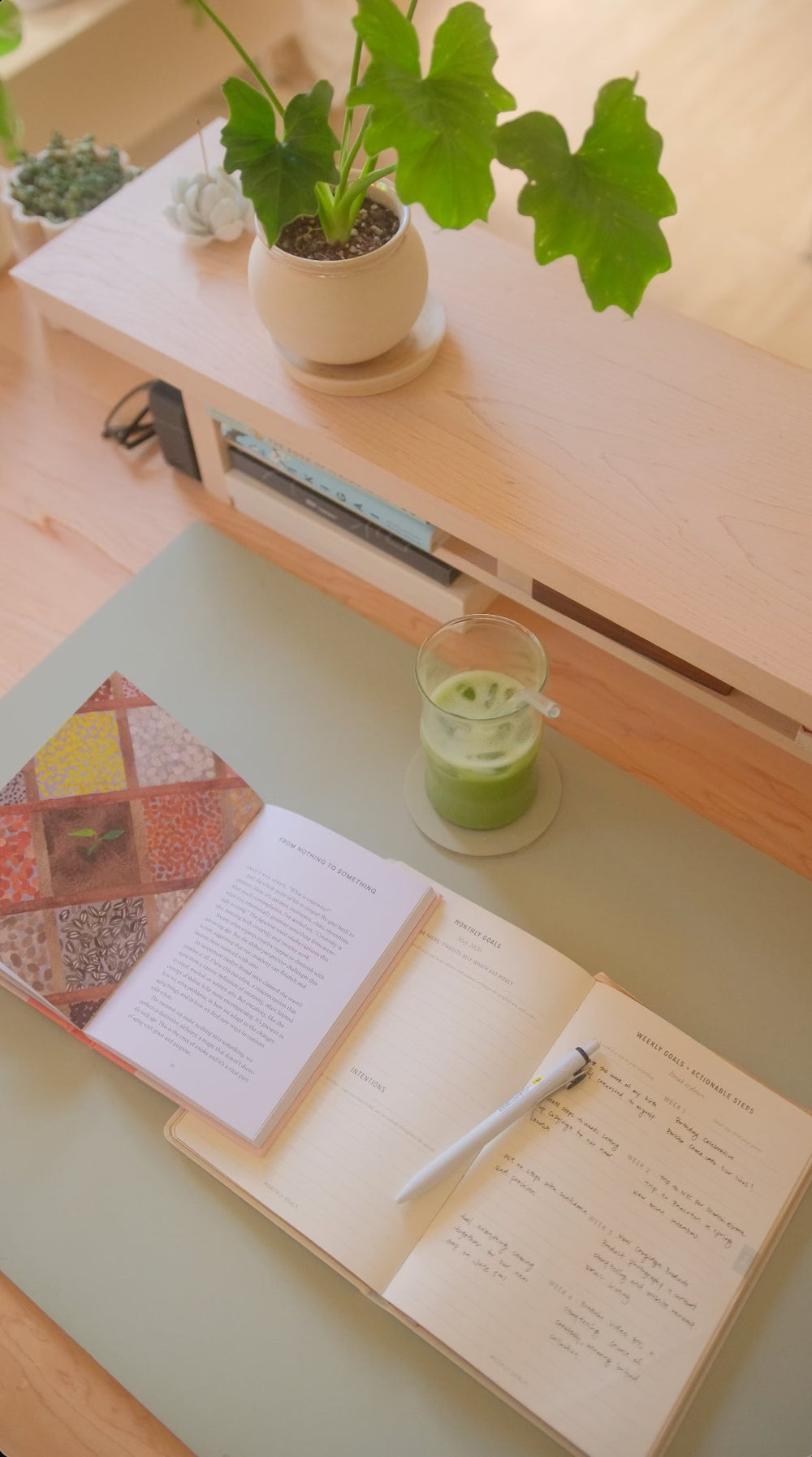 A Matcha Cozyleigh Desk Mat with a journal and a cup of matcha