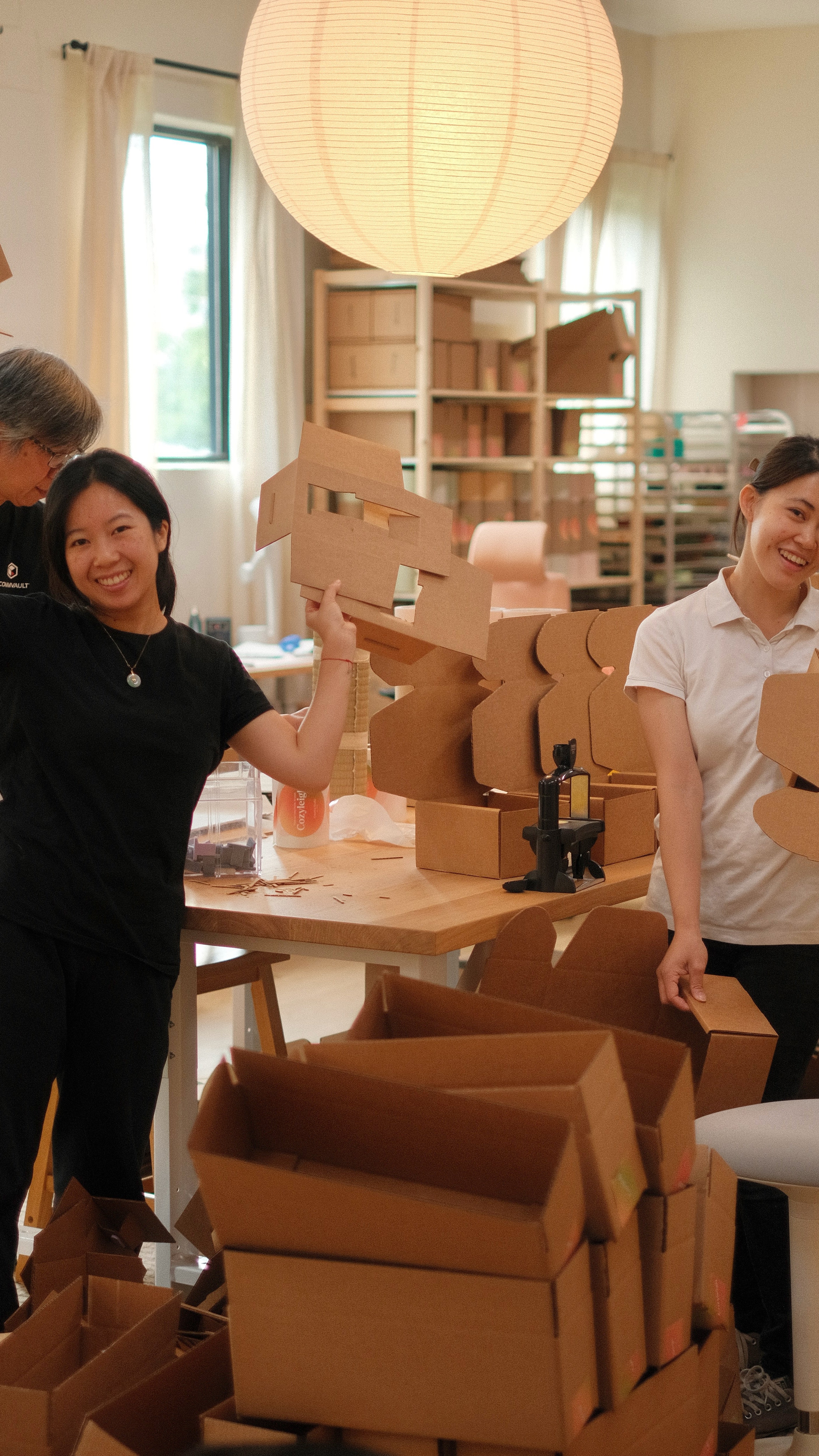 The family packing orders together in the studio