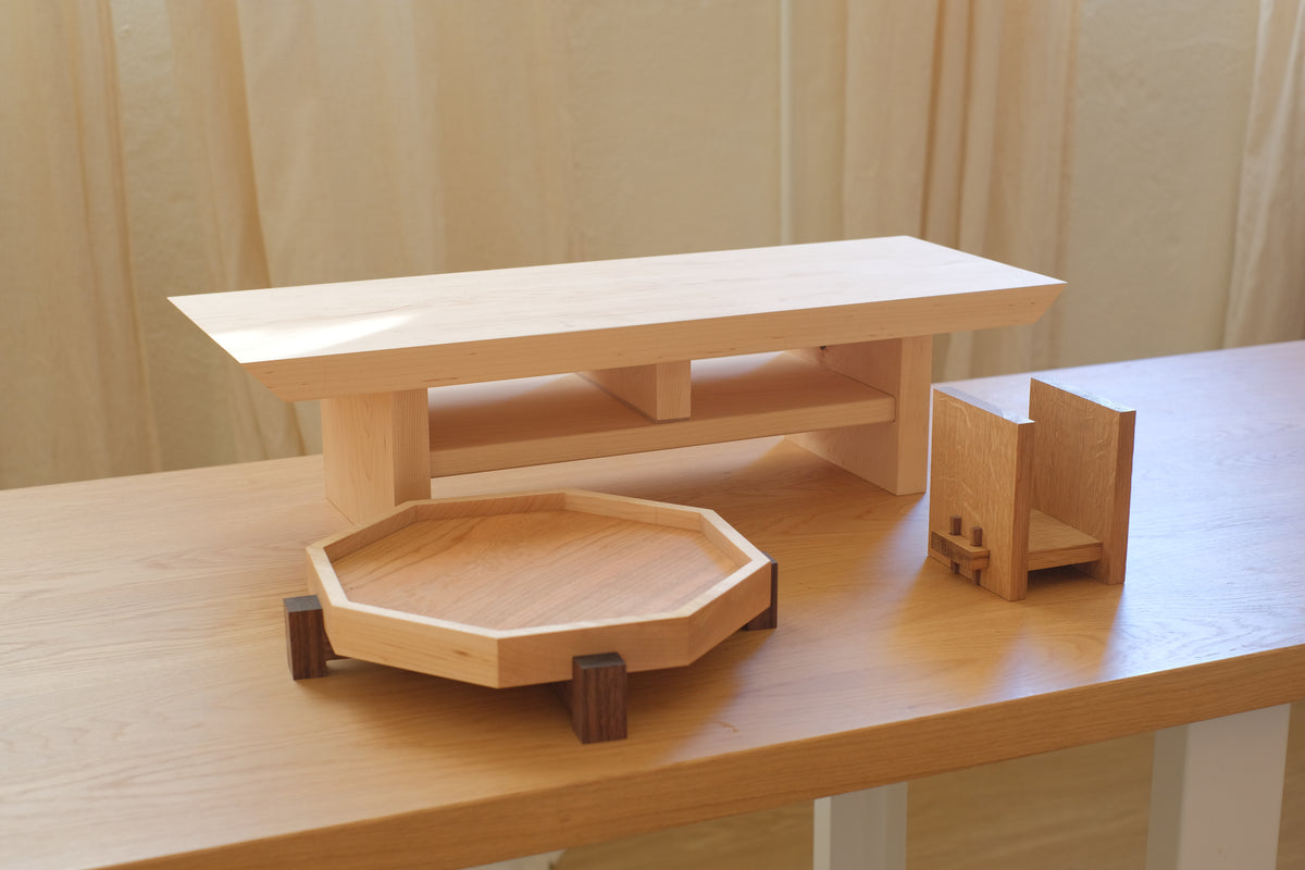 The Wood Collection at an angle: a maple Zen Desk Shelf, Zen Tray and Zen Book Stand on a wooden desk