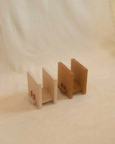 Zen Book Stands in Maple and White Oak side by side, showing the two wood tones