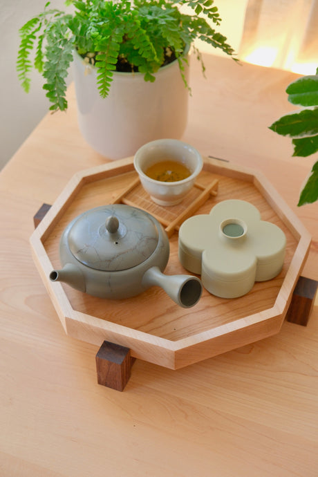 Zen Tray in Maple, Medium, holding a grey kyusu, a cup of tea and a Pistachio Fa Trinket Tray on the desk