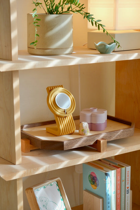 Zen Tray in Walnut, Large, on the maple shelf holding the Zen MagSafe Charger Stand in Ginkgo and a Lavender Fa Trinket Tray stack, sun across the wall (Lavender is coming this fall)
