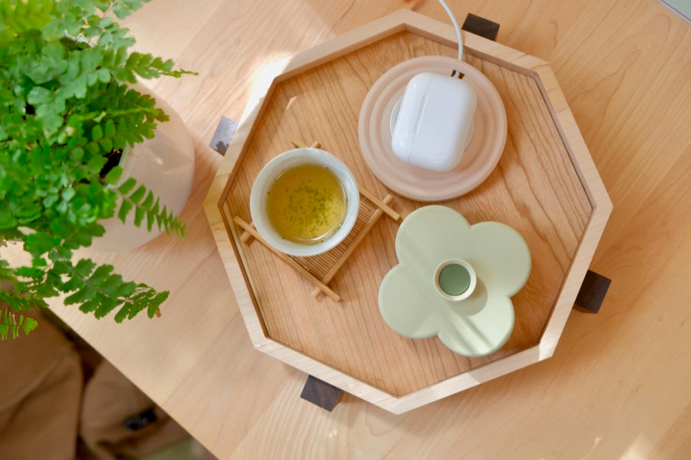 From above: a Charger Puck, a Fa Trinket Tray and a cup of tea on a maple Zen Tray