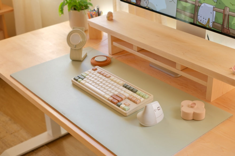 The cozy desk set from above: Charger Stand, Fa Trinket Tray, keyboard and mouse on a desk mat