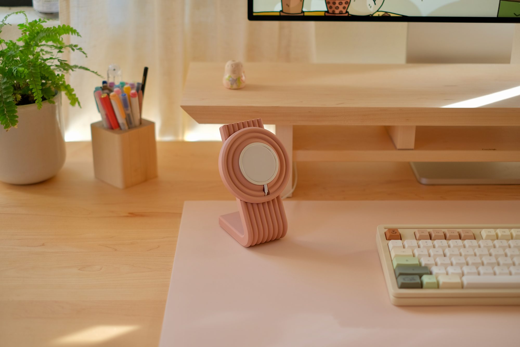 A Blush Cozyleigh Desk Mat with a Rose Zen MagSafe Charger Stand